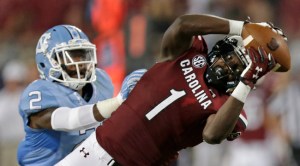 South Carolina's Deebo Samuel (1) reaches for a pass as North Carolina's Des Lawrence (2) defends in the second half of an NCAA college football game in Charlotte, N.C., Thursday, Sept. 3, 2015. The pass was incomplete. South Carolina won 17-13. (AP Photo/Chuck Burton)